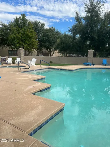 a living room with furniture gym equipment and a large window