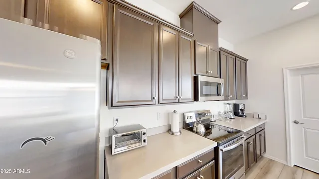 a kitchen with a refrigerator and a sink