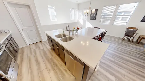 a kitchen with granite countertop a sink stove and refrigerator