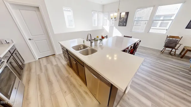a kitchen with granite countertop a sink stove and refrigerator