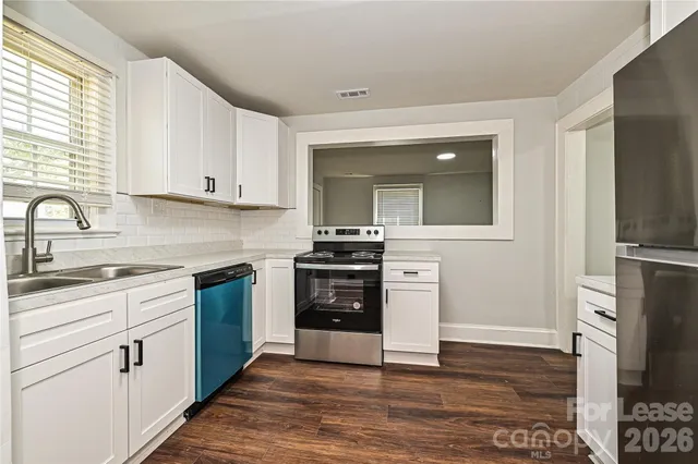 a kitchen with a sink stove and refrigerator