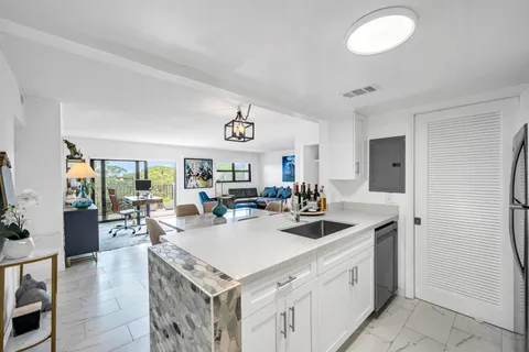 a view of a kitchen area with furniture and wooden floor