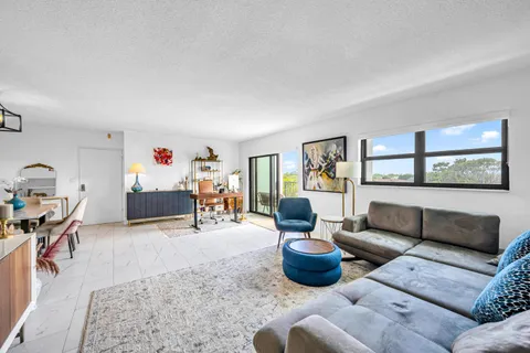 a living room filled with furniture and a wooden floor