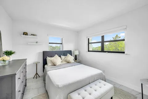 a bedroom with a bed and a table