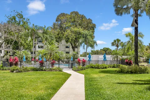 a view of a garden with a building in the background