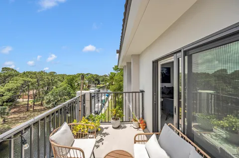 a view of a balcony with chair and wooden floor
