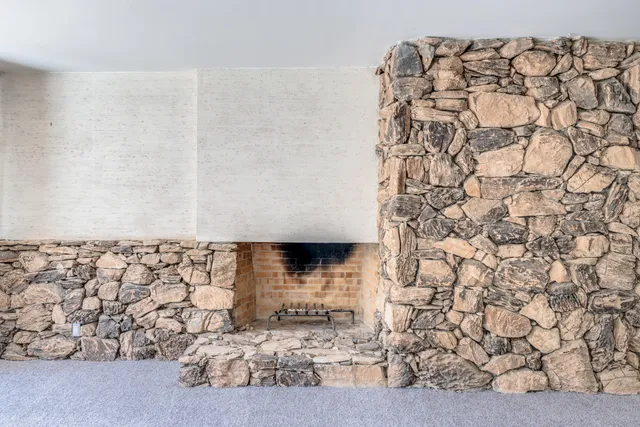 a view of kitchen with granite countertop cabinets