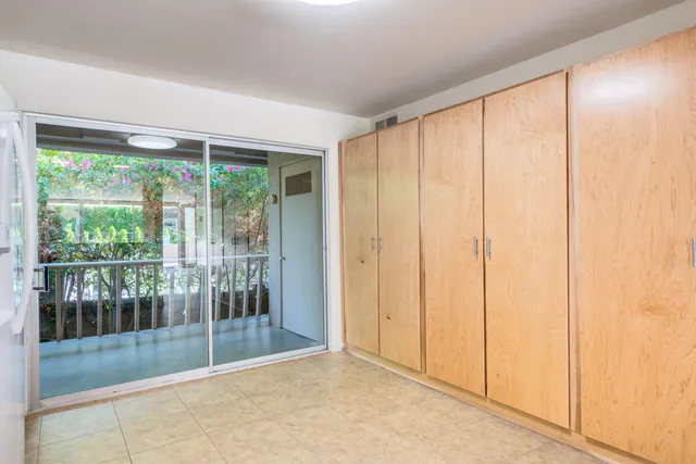 a view of a hallway with a kitchen