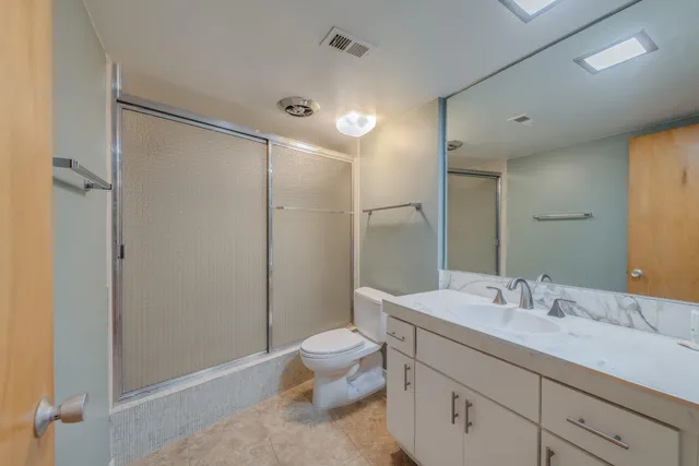 a bathroom with a sink toilet and shower