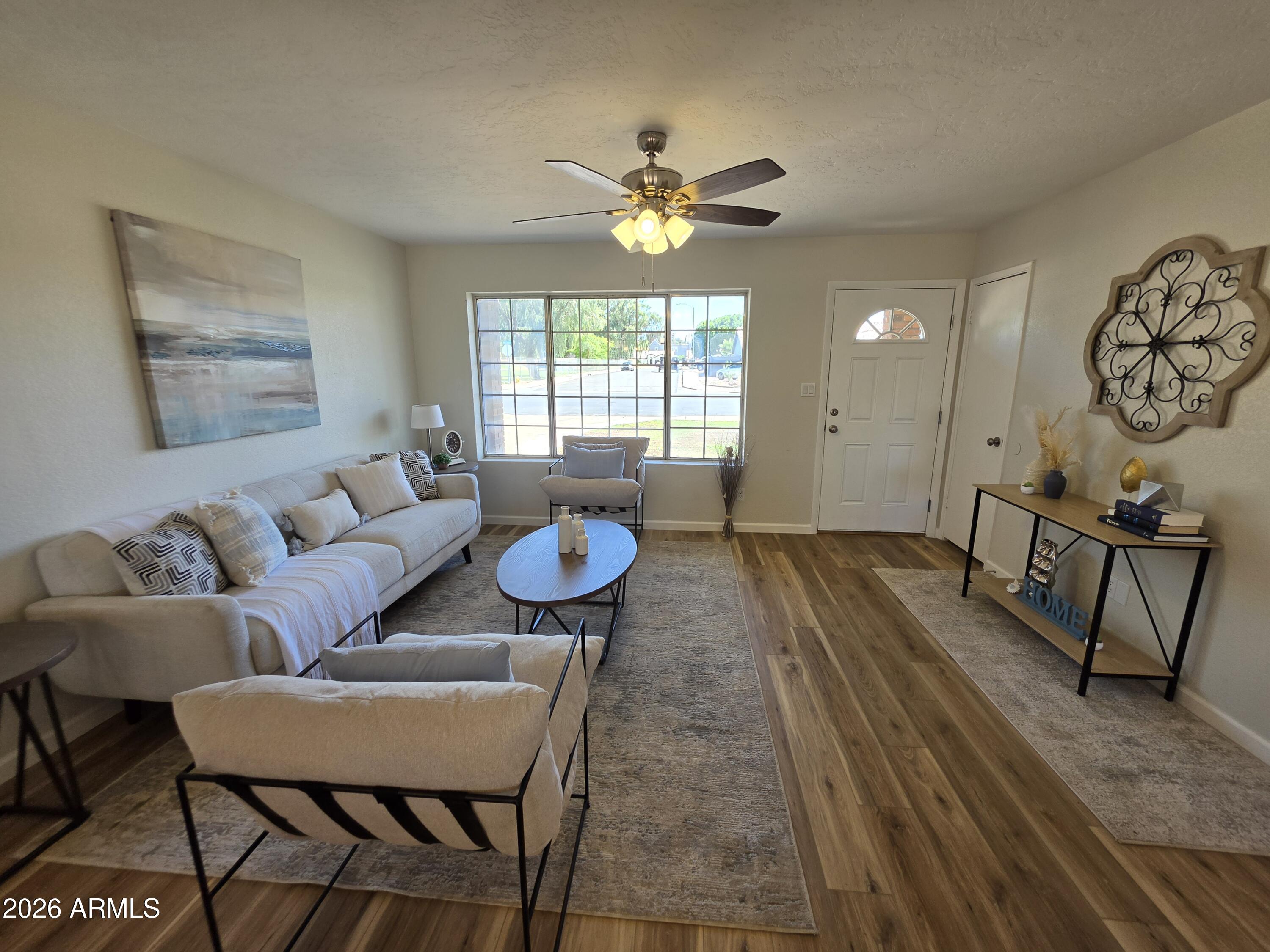 46 East McLellan Road Mesa, AZ 85201 - Photo 3 of 18 a living room with furniture and a chandelier