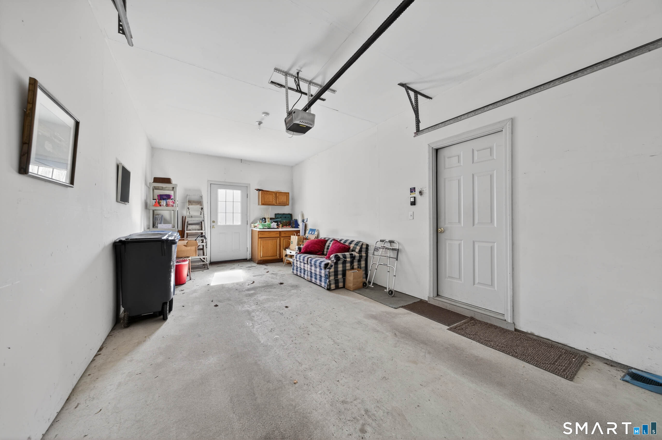 65 Forest Road, Unit D Milford, CT 06461 - Photo 32 of 39 The deep one car garage provides access to the house, and the patio area.