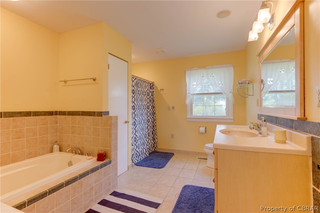 351 Reeves Road Hudgins, VA 23076 - Photo 23 of 41 a bathroom with a tub sink and mirror