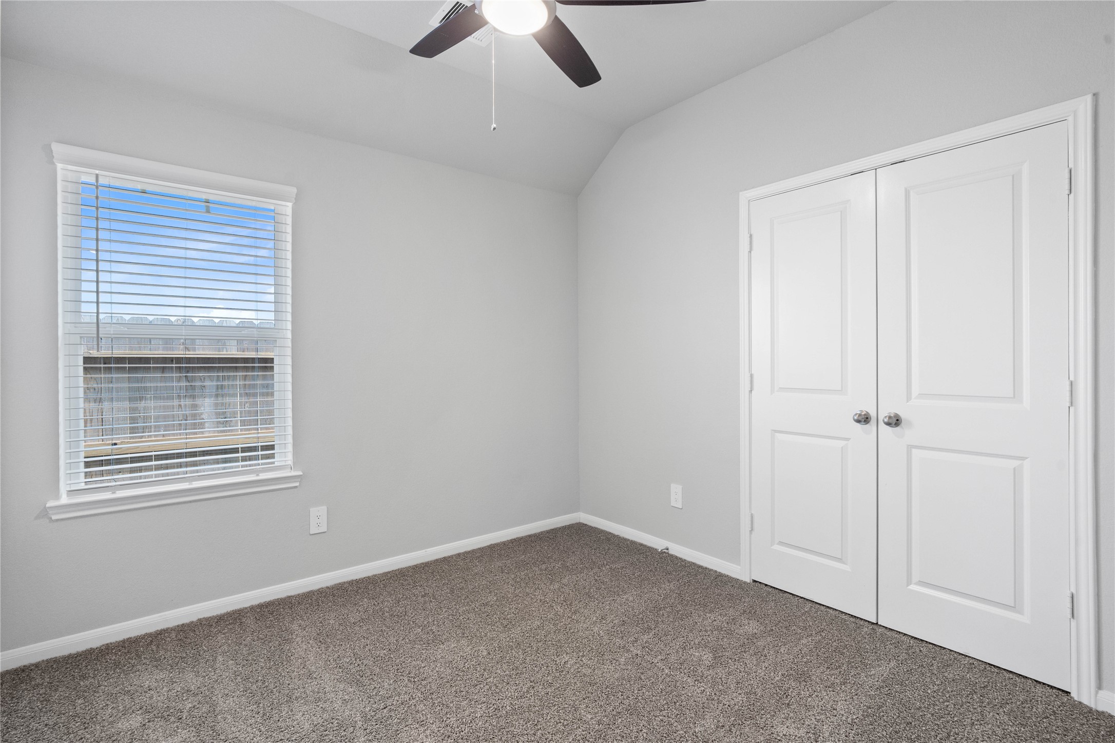 19555 Montgomery Rdg Way Montgomery, TX 77316 - Photo 12 of 38 Perfect for guests or a quiet home office, this room features soft plush carpeting, a window with fitted blinds, sloped ceiling, and ample sized closet space.