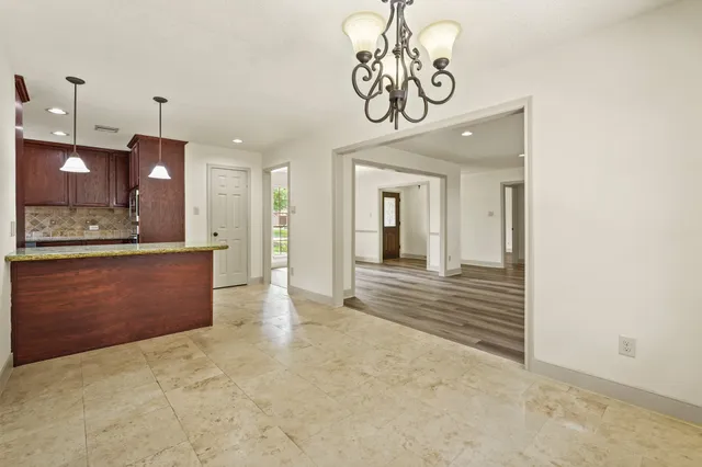 a view of a hallway with granite countertop a couch