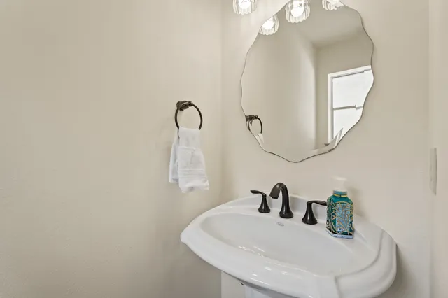 a bathroom with a sink and mirror