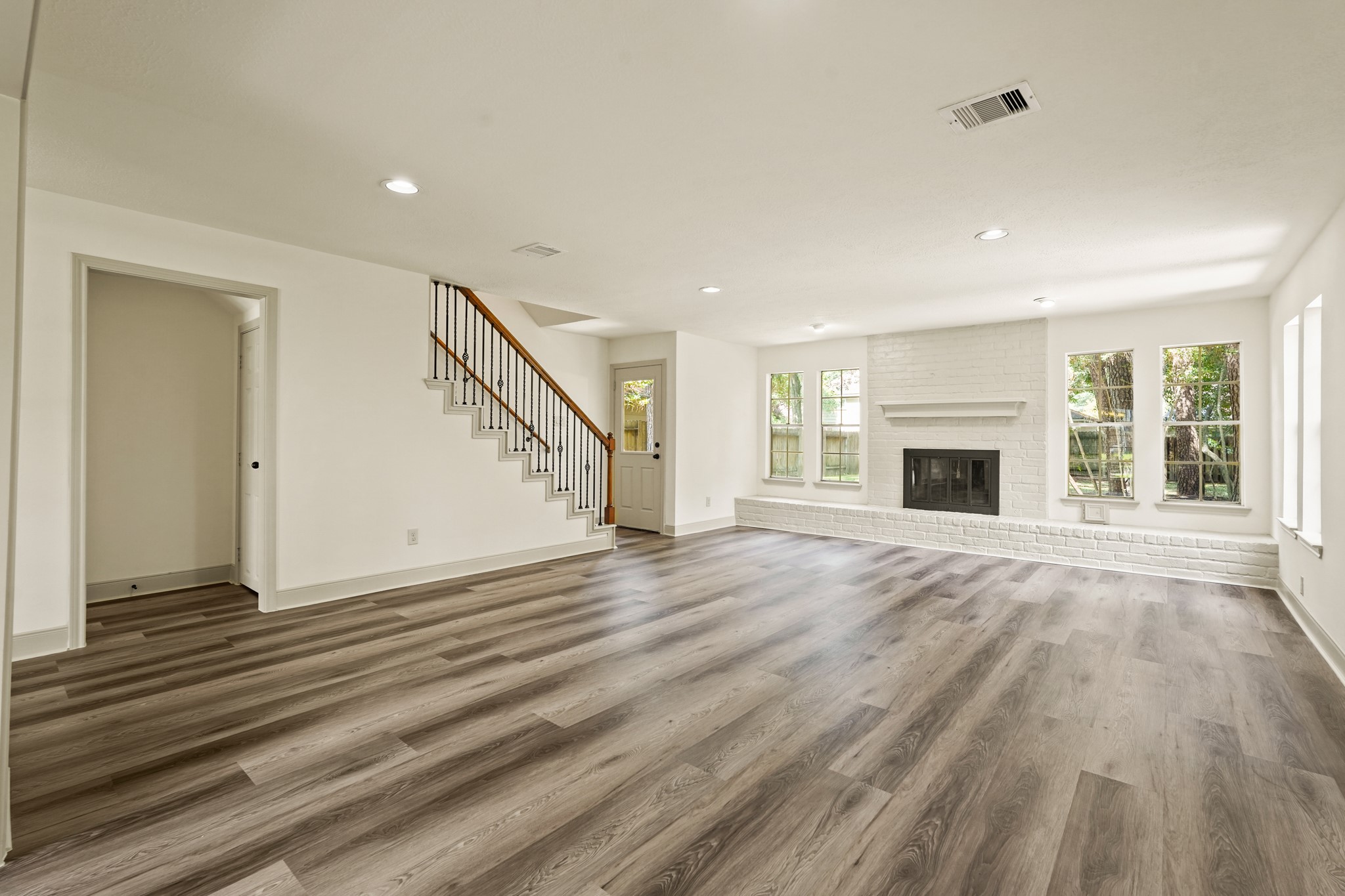 17606 Rustington Drive Spring, TX 77379 - Photo 17 of 44 a view of empty room with wooden floor and fireplace