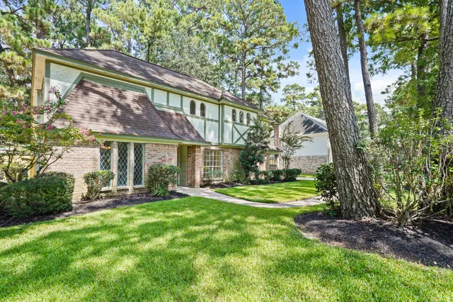 a view of a house with a yard and sitting area