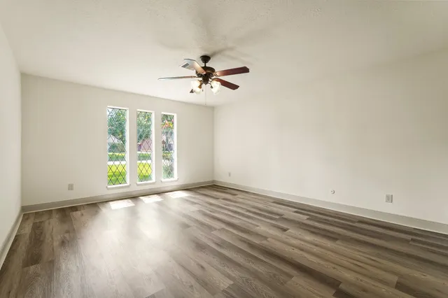 wooden floor in an empty room with a window