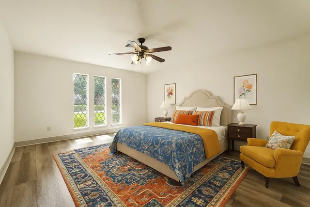 a bedroom with a bed a couch and a window