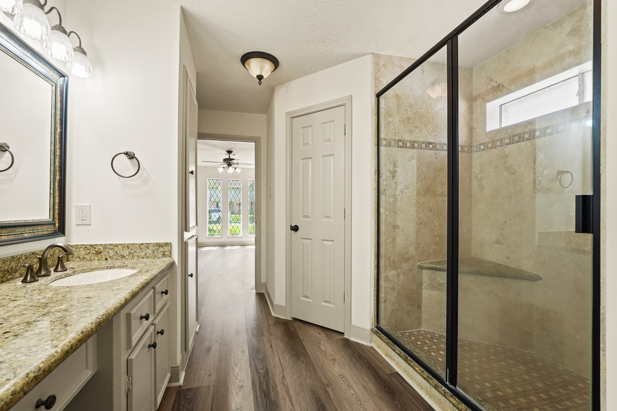 17606 Rustington Drive Spring, TX 77379 - Photo 28 of 44 a spacious bathroom with a granite countertop sink mirror and shower