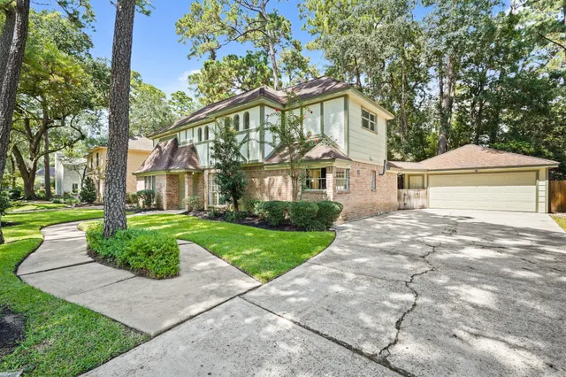 a front view of a house with a yard and a garage