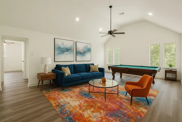 a living room with furniture a ceiling fan and a window