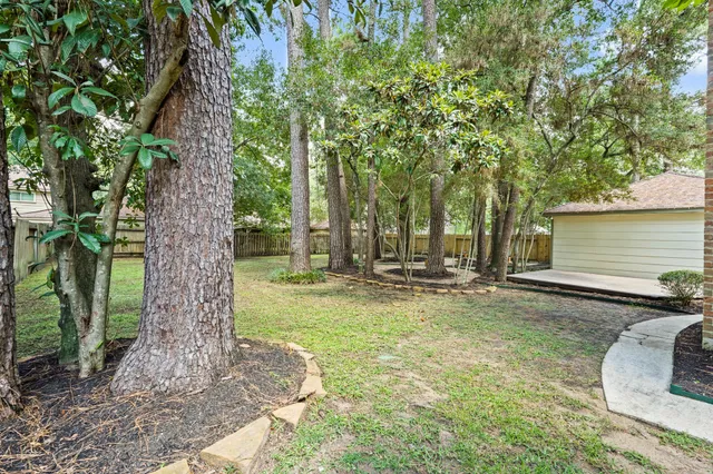 a backyard of a house with table and chairs