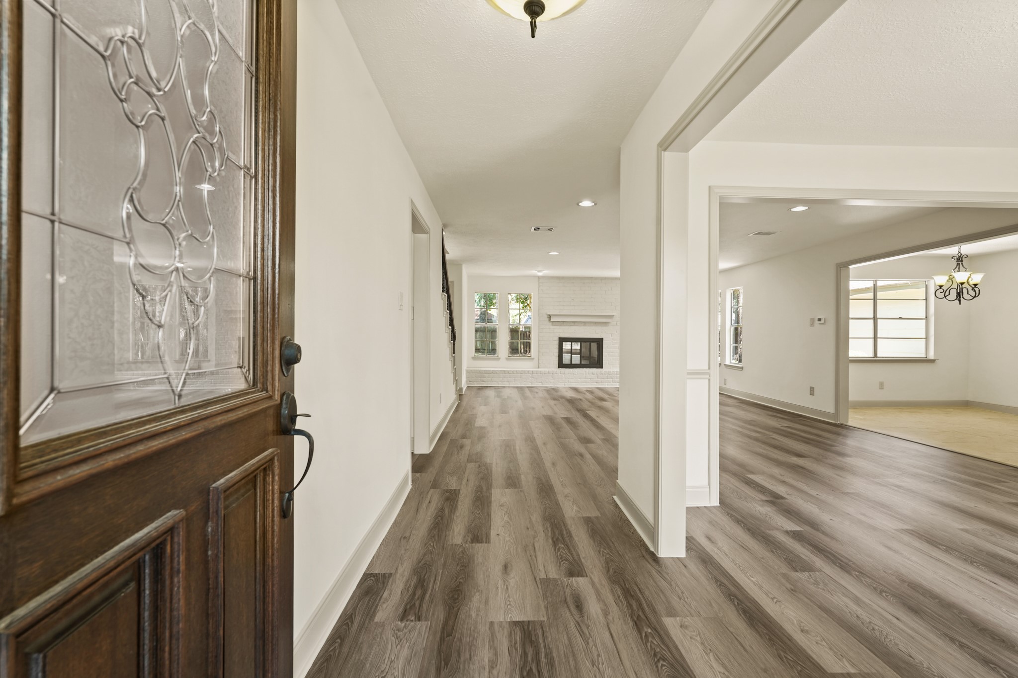 17606 Rustington Drive Spring, TX 77379 - Photo 5 of 44 a view of a hallway with wooden floor and stairs