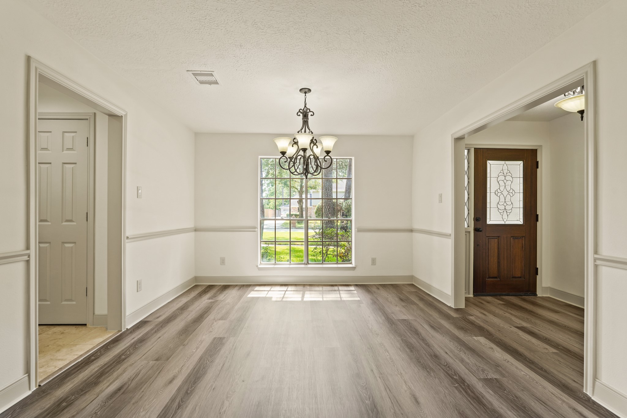 17606 Rustington Drive Spring, TX 77379 - Photo 8 of 44 a view of an empty room with wooden floor and a window