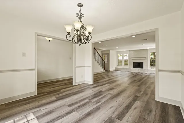 a view of a livingroom with wooden floor and a ceiling fan
