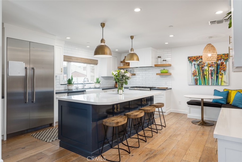 620 Gary Place Newport Beach, CA 92663 - Photo 11 of 36 a kitchen with stainless steel appliances kitchen island granite countertop a sink a stove and a refrigerator