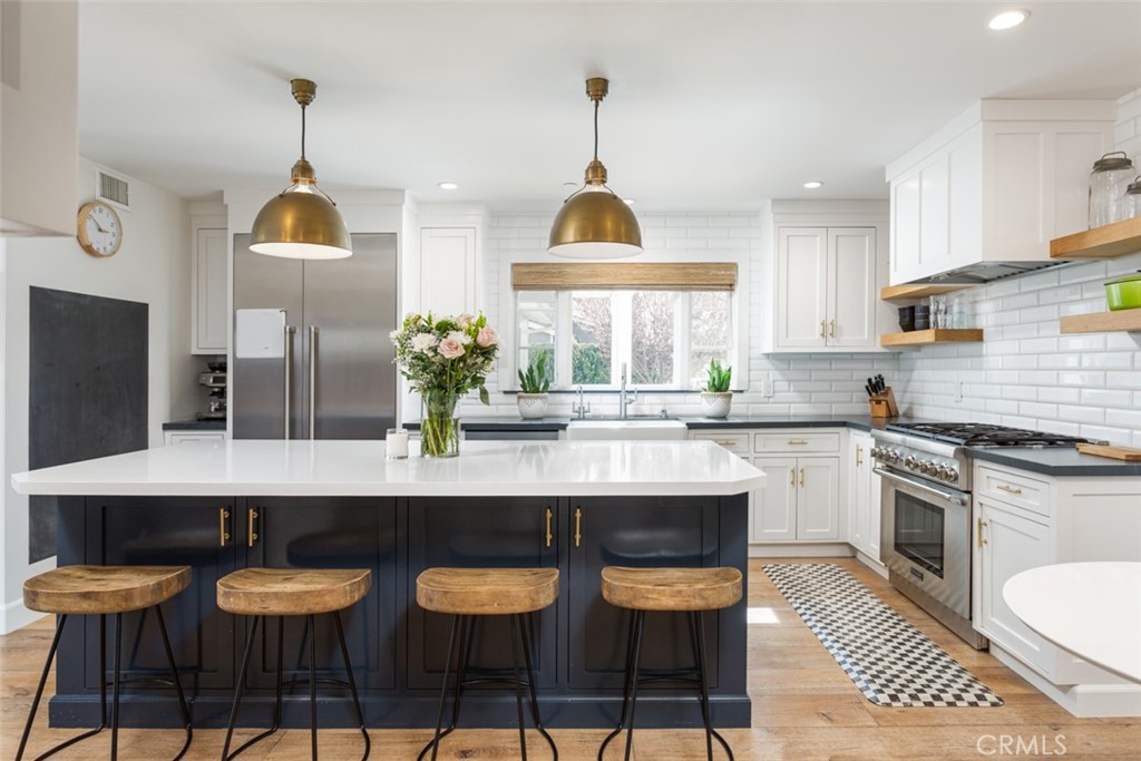 620 Gary Place Newport Beach, CA 92663 - Photo 12 of 36 a kitchen with granite countertop a counter space chairs stainless steel appliances and cabinets