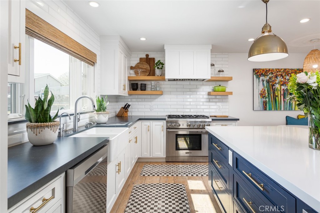 620 Gary Place Newport Beach, CA 92663 - Photo 14 of 36 a kitchen with a sink stove and cabinets