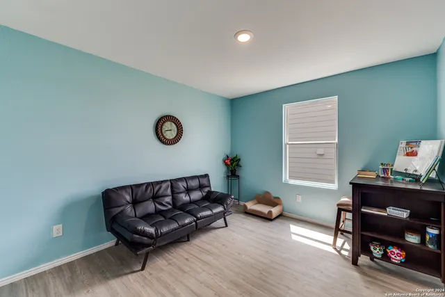a living room with furniture a window and a table