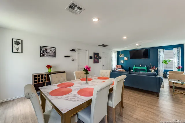 a view of a dining room with furniture and wooden floor