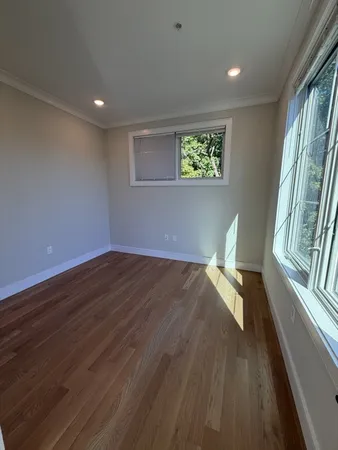 a view of a livingroom with wooden floor and a window