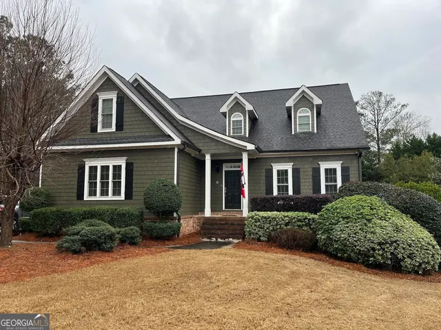 a front view of a house with yard and green space