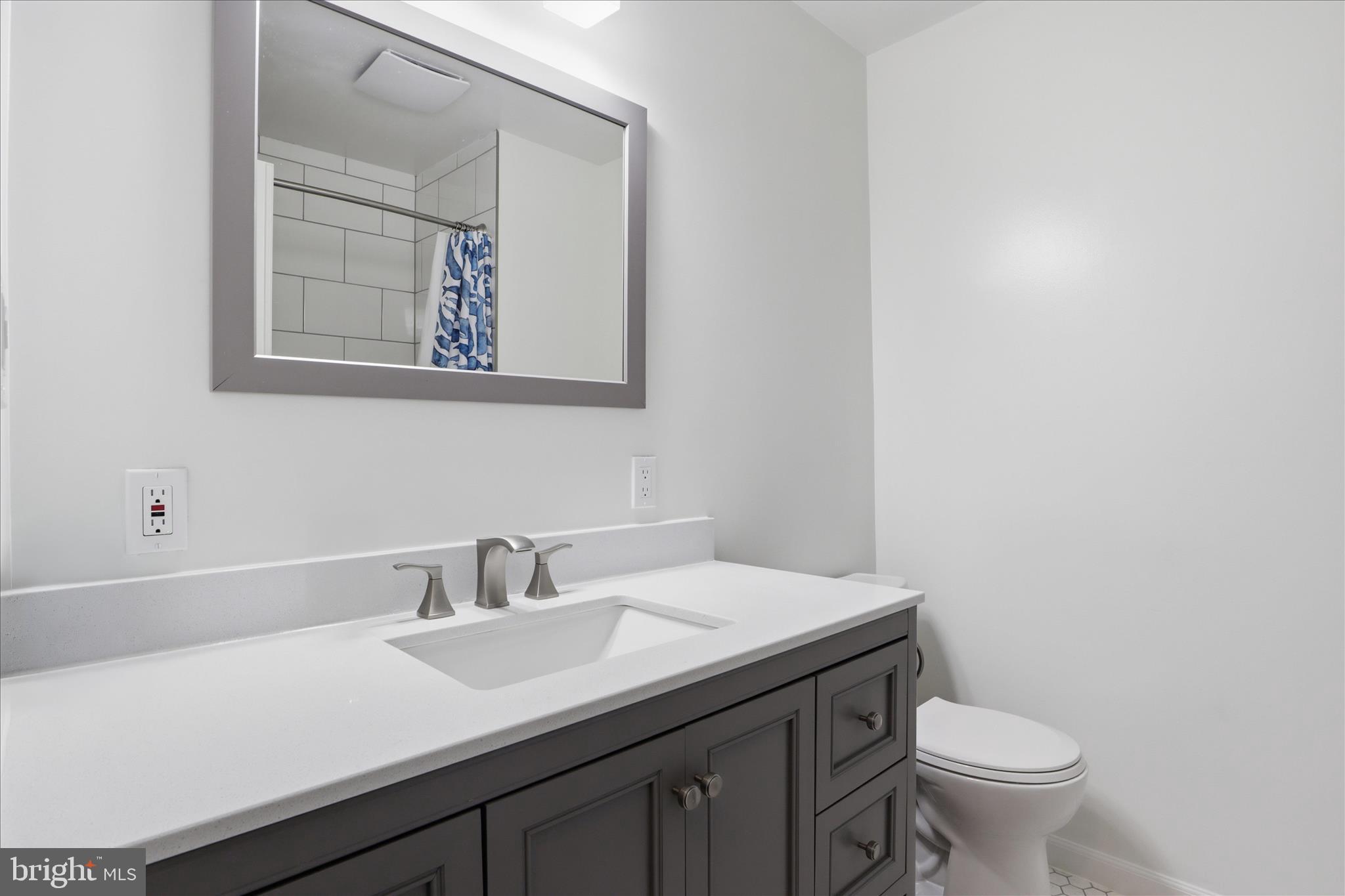 1600 Billman Lane Silver Spring, MD 20902 - Photo 17 of 41 a bathroom with a toilet a sink and mirror