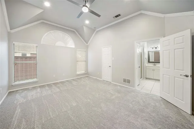 an empty room with fan and entrance