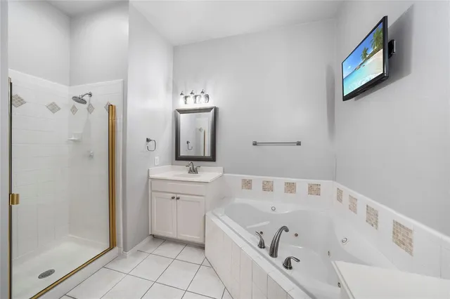 a bathroom with a tub sink and mirror