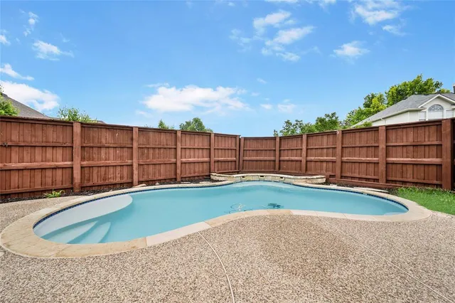 a view of a swimming pool with a lawn chairs