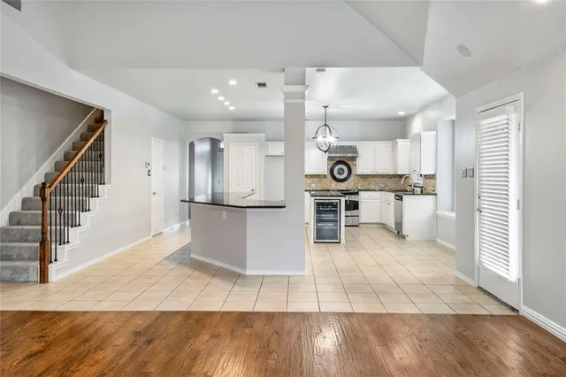 a view of kitchen with stainless steel appliances kitchen island lots of wooden cabinets a sink and a stove