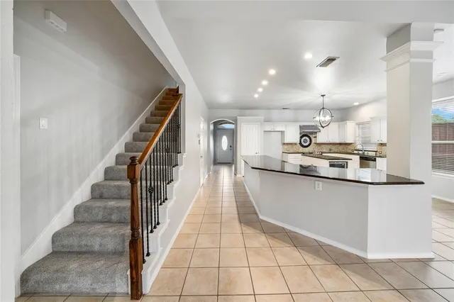 a view of a kitchen with kitchen and staircase