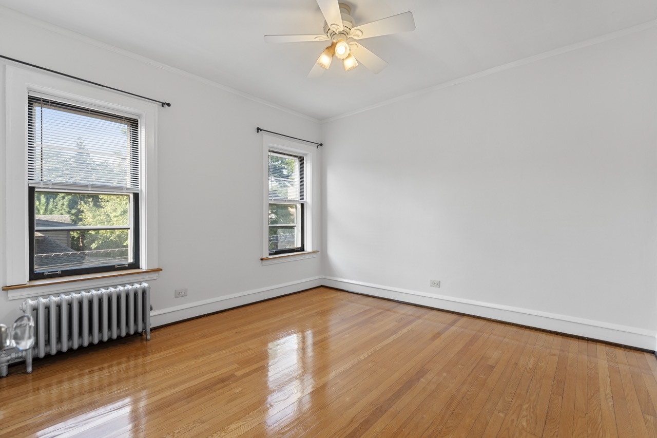816 Mulford Street, Unit 2R Evanston, IL 60202 - Photo 12 of 13 wooden floor in an empty room with a window