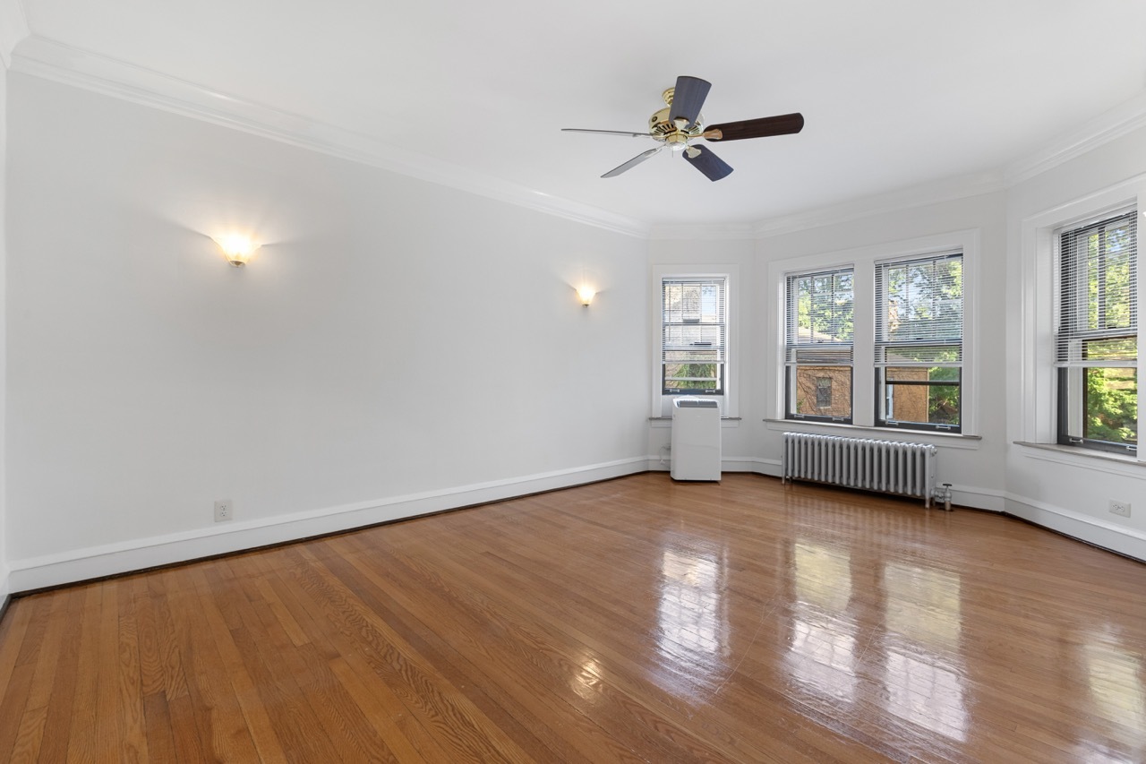 816 Mulford Street, Unit 2R Evanston, IL 60202 - Photo 2 of 13 wooden floor in an empty room with a window