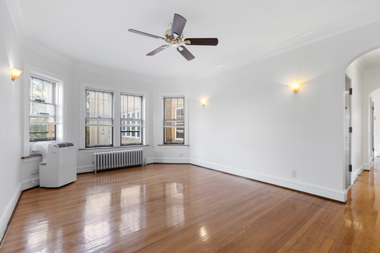 816 Mulford Street, Unit 2R Evanston, IL 60202 - Photo 3 of 13 a view of an empty room with a window and wooden floor