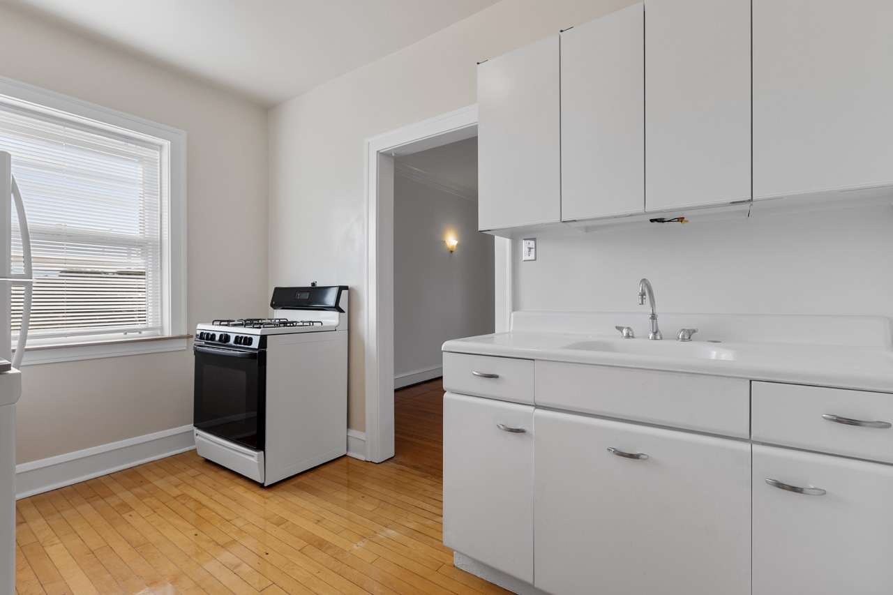 816 Mulford Street, Unit 2R Evanston, IL 60202 - Photo 4 of 13 a kitchen with stainless steel appliances white cabinets and a sink
