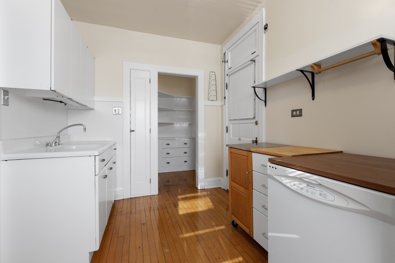 816 Mulford Street, Unit 2R Evanston, IL 60202 - Photo 6 of 13 a kitchen with a sink and a refrigerator