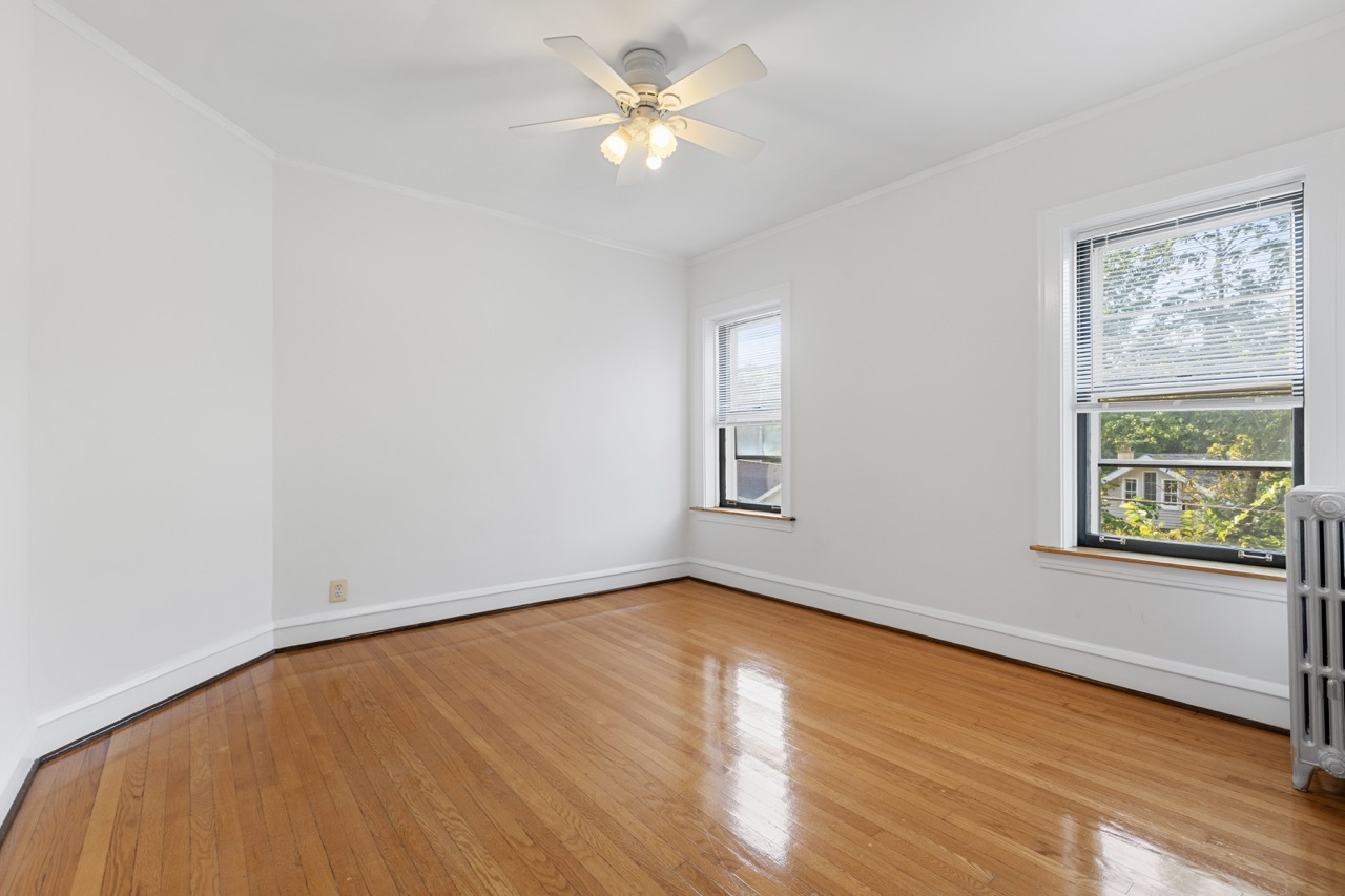 816 Mulford Street, Unit 2R Evanston, IL 60202 - Photo 10 of 13 an empty room with a window and a ceiling fan