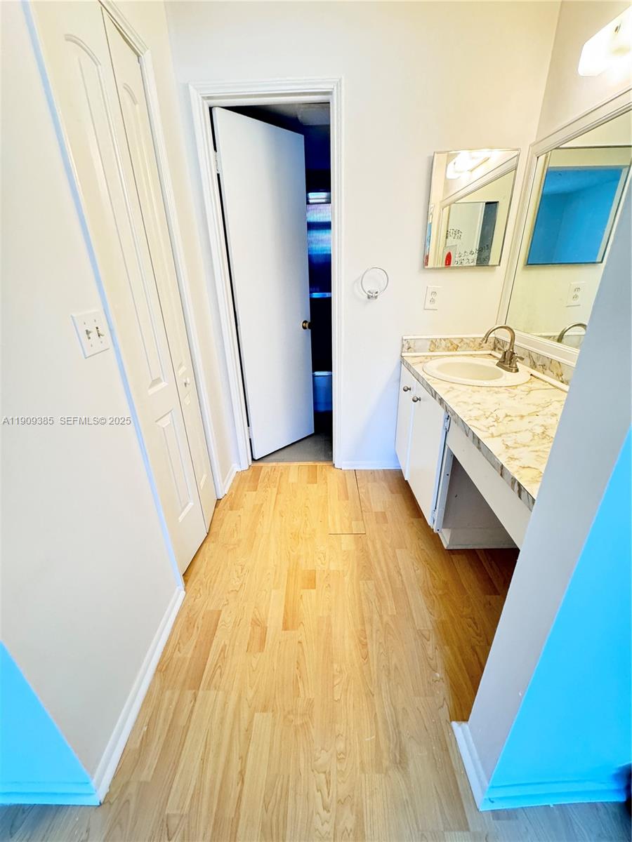 9441 Evergreen Place, Unit 206 Davie, FL 33324 - Photo 6 of 11 a bathroom with a granite countertop sink and a mirror